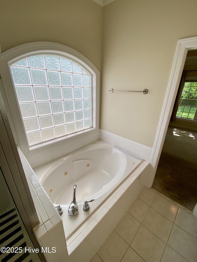 full bath with a jetted tub and tile patterned flooring