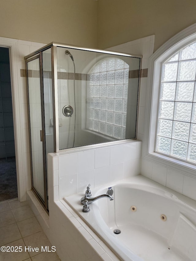 full bathroom featuring a stall shower, tile patterned flooring, and a jetted tub