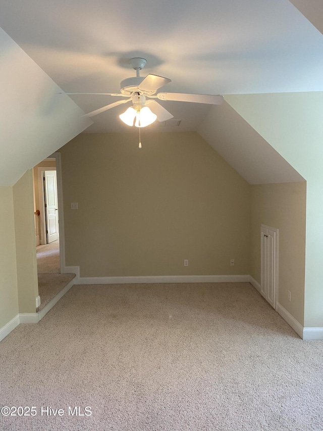 bonus room featuring light carpet, ceiling fan, vaulted ceiling, and baseboards