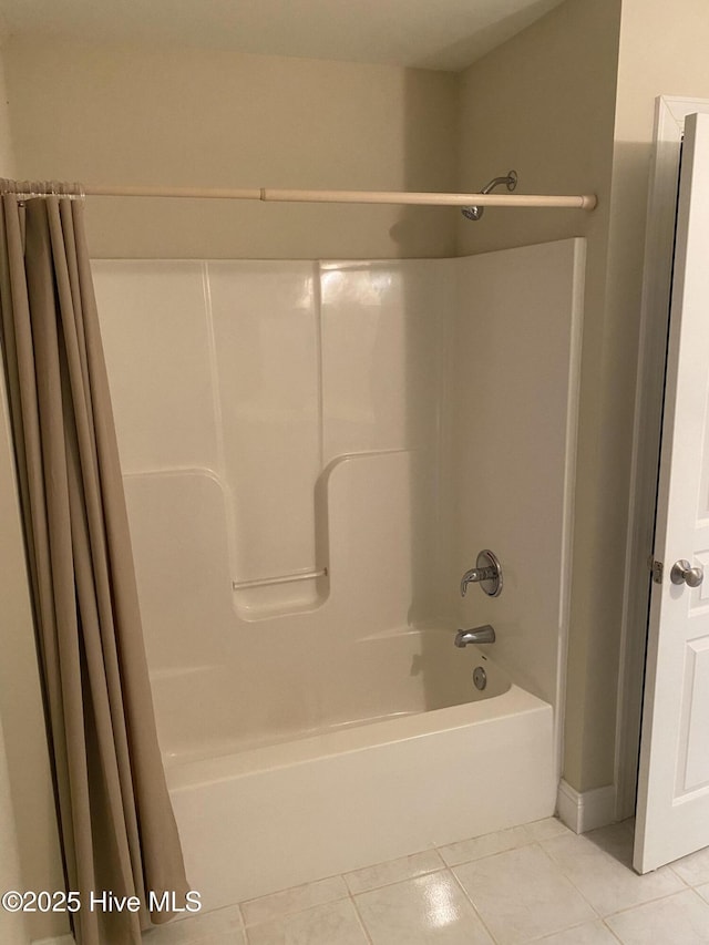 full bath featuring tile patterned flooring and shower / bath combo with shower curtain