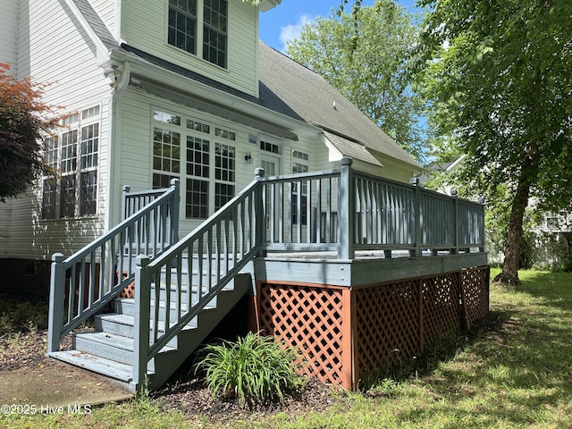 rear view of property with roof with shingles and a deck
