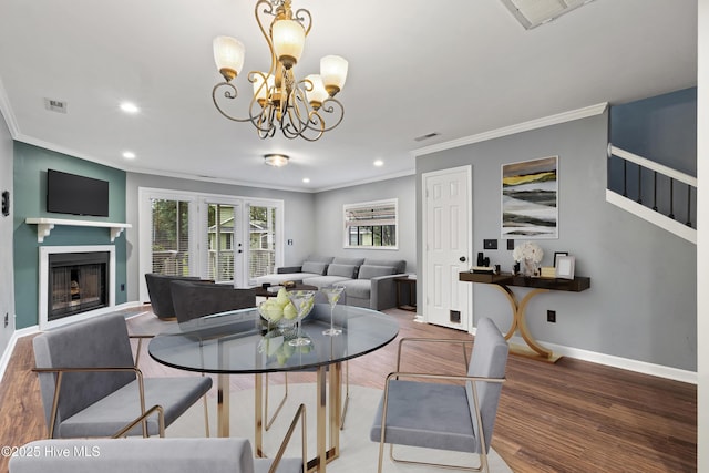dining room with ornamental molding, recessed lighting, wood finished floors, a chandelier, and baseboards