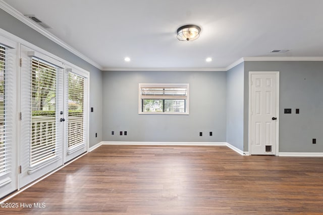empty room with wood finished floors, baseboards, crown molding, recessed lighting, and french doors