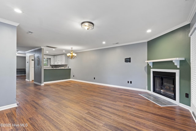 unfurnished living room with a chandelier, a fireplace, dark wood-style floors, recessed lighting, and ornamental molding