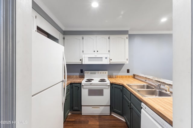 kitchen featuring white appliances, a sink, crown molding, dark wood-style floors, and light countertops