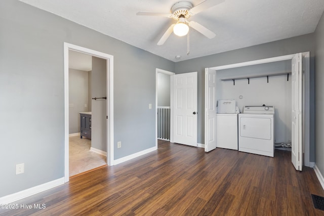 washroom featuring independent washer and dryer, dark wood finished floors, a ceiling fan, and baseboards