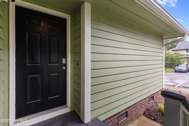 view of exterior entry featuring crawl space