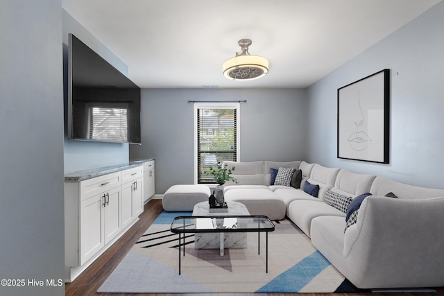 living area featuring dark wood-style floors and baseboards