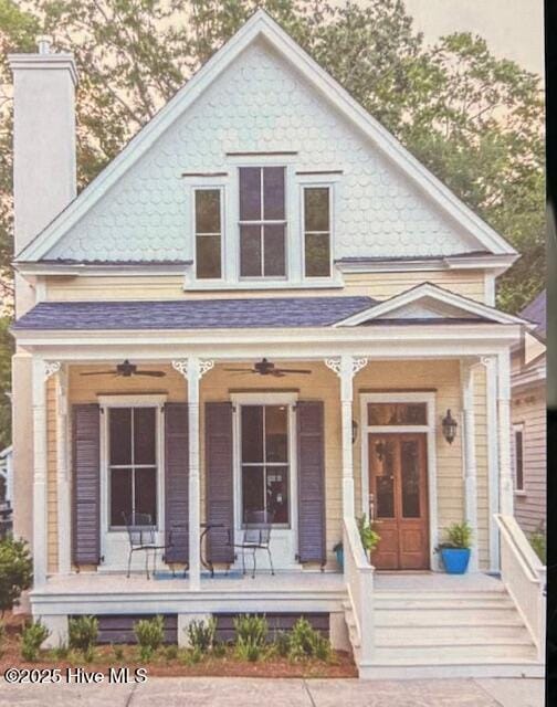 view of front of property with covered porch, a chimney, and ceiling fan