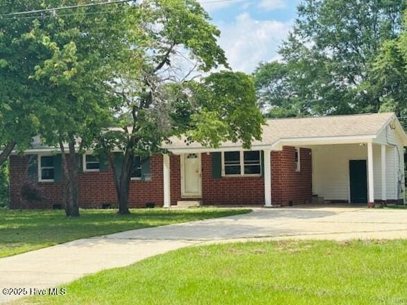 6007 Meadow Ln, Goldsboro, NC 27530 - ranch-style house with driveway, a front yard, a carport, and brick siding