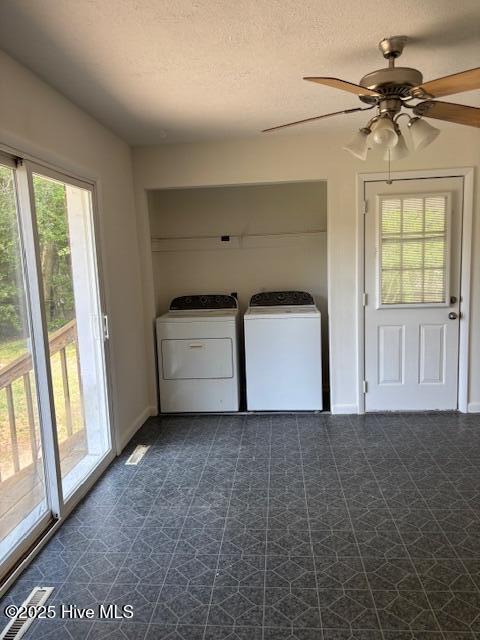 6007 Meadow Ln, Goldsboro, NC 27530 - laundry area featuring washer and dryer, ceiling fan, baseboards, a textured ceiling, and dark floors