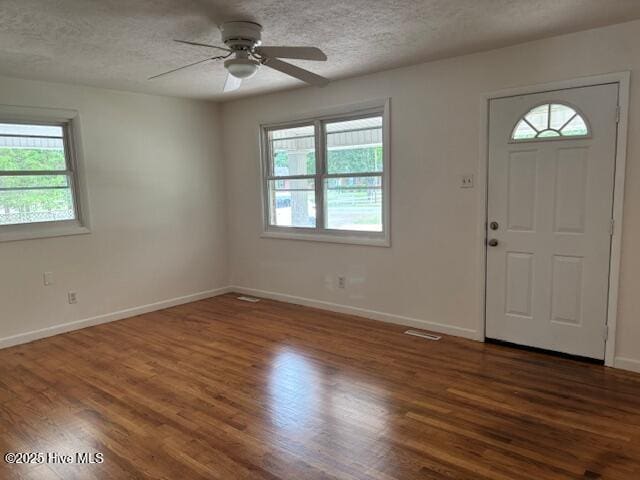 6007 Meadow Ln, Goldsboro, NC 27530 - foyer entrance with dark wood-type flooring, a textured ceiling, ceiling fan, and baseboards