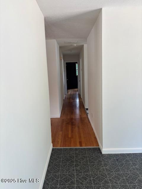 6007 Meadow Ln, Goldsboro, NC 27530 - hallway with baseboards and dark floors