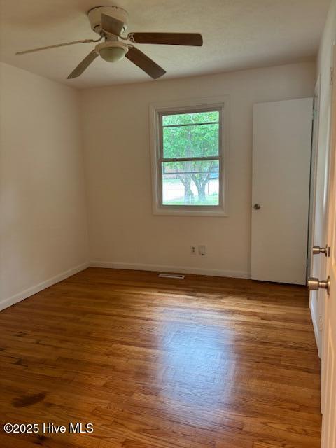 6007 Meadow Ln, Goldsboro, NC 27530 - empty room featuring wood finished floors, a ceiling fan, and baseboards