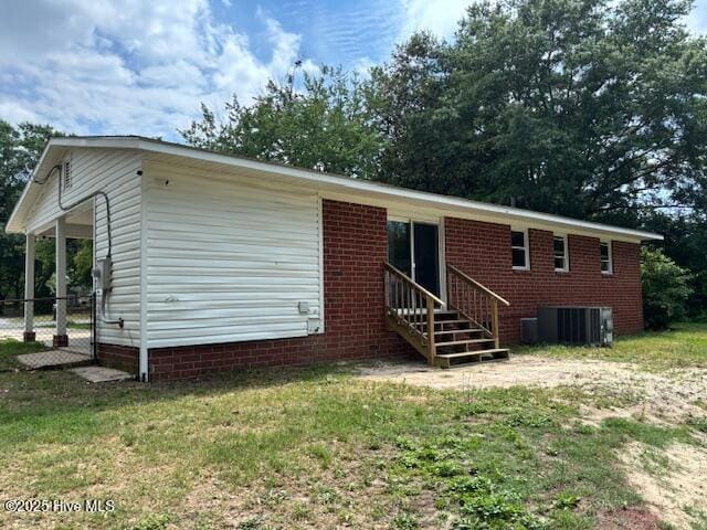 6007 Meadow Ln, Goldsboro, NC 27530 - rear view of house featuring central AC, entry steps, and a lawn