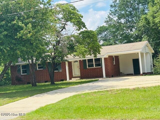 6007 Meadow Ln, Goldsboro, NC 27530 - ranch-style home with concrete driveway, a front yard, an attached carport, crawl space, and brick siding