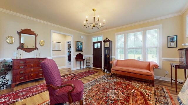 4083 Reunion Pointe Ln, New Bern, NC 28562 - living area with a chandelier, wood finished floors, ornamental molding, and baseboards