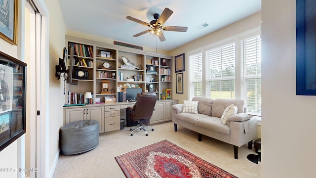 office area with light colored carpet and a ceiling fan