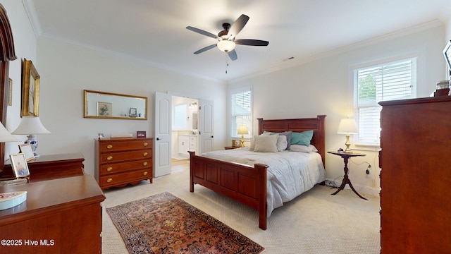 bedroom featuring multiple windows, light colored carpet, crown molding, connected bathroom, and baseboards