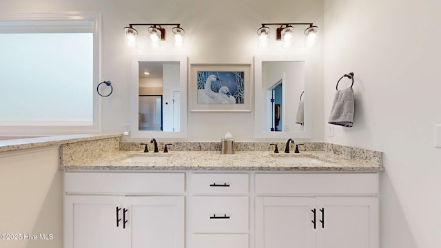 bathroom featuring double vanity and a shower