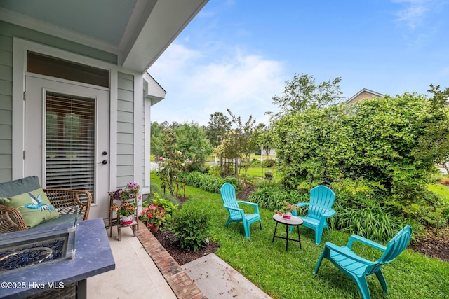 view of yard featuring a patio and an outdoor fire pit