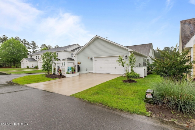 view of front of home featuring a garage, a front lawn, and concrete driveway