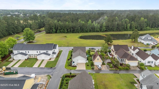 aerial perspective of suburban area with a heavily wooded area and a nearby body of water