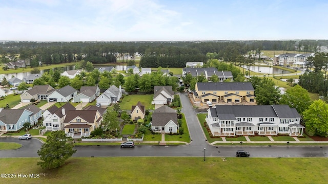 aerial view of residential area featuring a large body of water