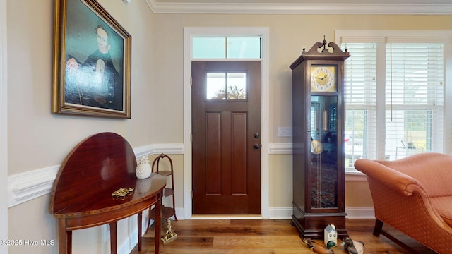foyer entrance featuring wood finished floors and ornamental molding
