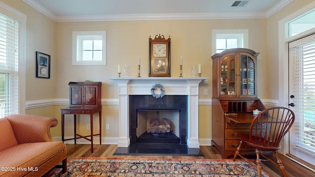 4083 Reunion Pointe Ln, New Bern, NC 28562 - sitting room featuring wood finished floors, crown molding, a fireplace with raised hearth, and plenty of natural light
