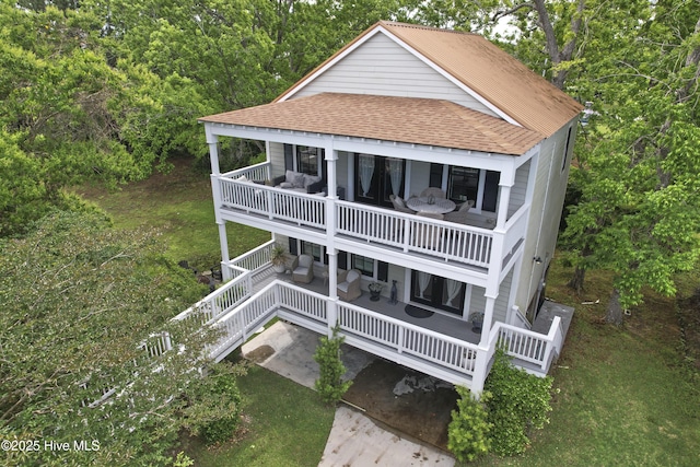 297 Broad St, Oriental, NC 28571 - back of house with roof with shingles, a balcony, and a yard