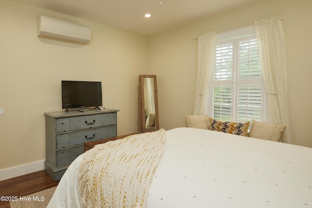 297 Broad St, Oriental, NC 28571 - bedroom featuring an AC wall unit, dark wood-style flooring, recessed lighting, and baseboards