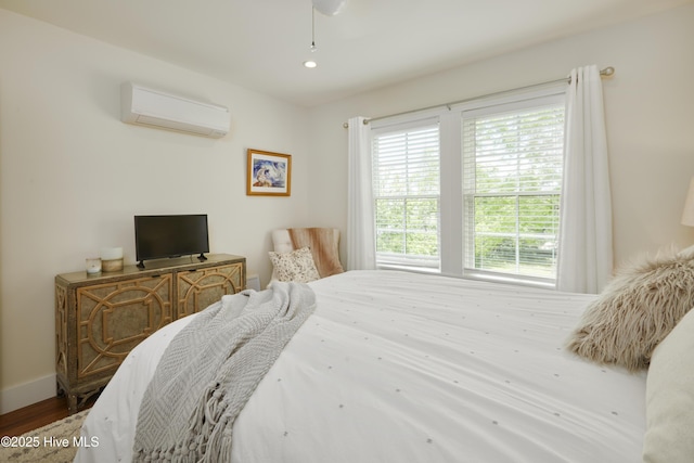 297 Broad St, Oriental, NC 28571 - bedroom with a wall unit AC, wood finished floors, baseboards, and recessed lighting
