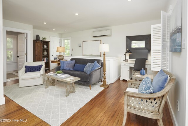297 Broad St, Oriental, NC 28571 - living area with a wall mounted air conditioner, wood-type flooring, a desk, recessed lighting, and a wainscoted wall