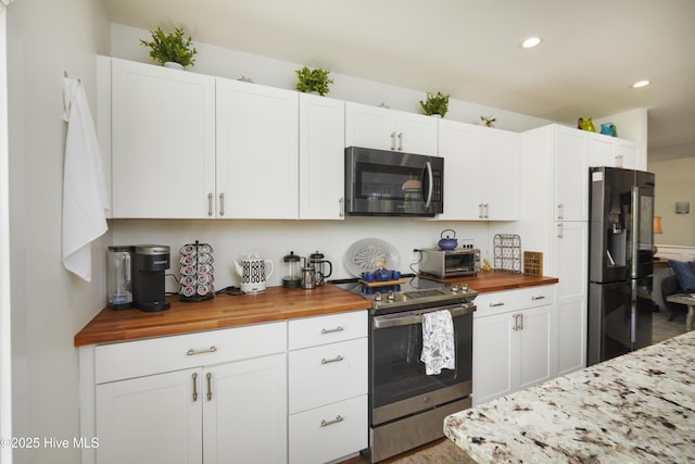 297 Broad St, Oriental, NC 28571 - kitchen featuring stainless steel appliances, wood counters, recessed lighting, white cabinets, and wood finished floors