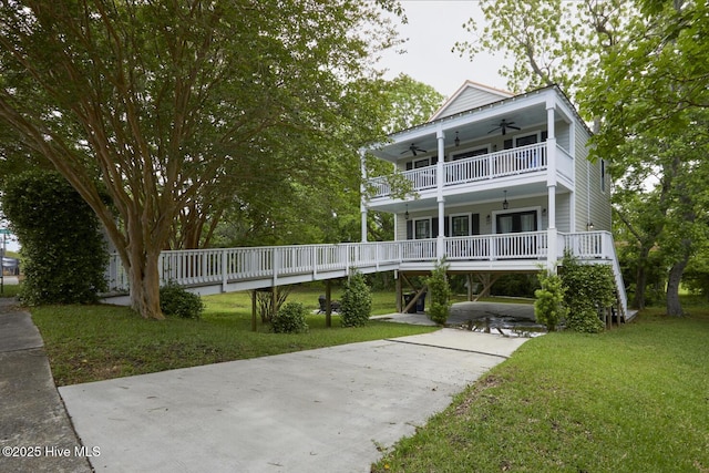 297 Broad St, Oriental, NC 28571 - view of front of house featuring a ceiling fan, a front lawn, and a balcony