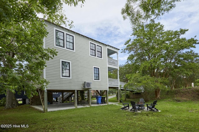 297 Broad St, Oriental, NC 28571 - rear view of house with a balcony, a yard, a fire pit, and stairs