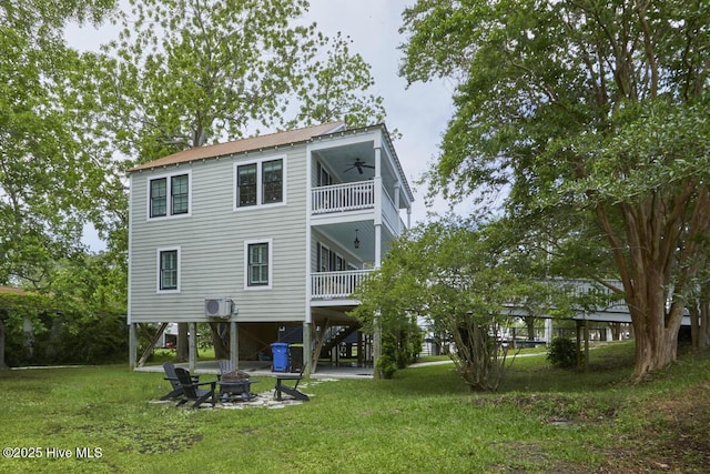 297 Broad St, Oriental, NC 28571 - rear view of property featuring a fire pit, stairs, a lawn, and a balcony