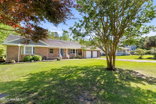 205 Sand Dollar Ln, Hampstead, NC 28443 - ranch-style home featuring an attached garage, a front yard, brick siding, and driveway