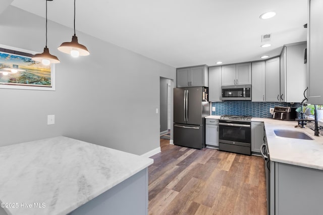 205 Sand Dollar Ln, Hampstead, NC 28443 - kitchen featuring appliances with stainless steel finishes, gray cabinetry, a sink, backsplash, and recessed lighting