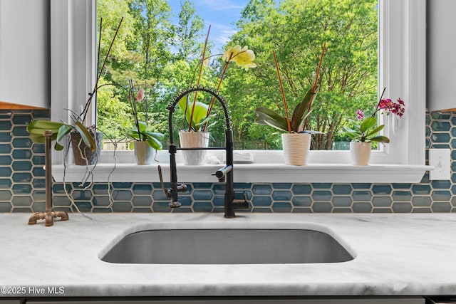 205 Sand Dollar Ln, Hampstead, NC 28443 - kitchen view of tasteful backsplash, a sink, and light stone counters