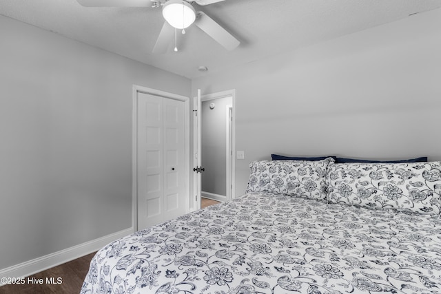 205 Sand Dollar Ln, Hampstead, NC 28443 - bedroom with wood finished floors, baseboards, a closet, and ceiling fan