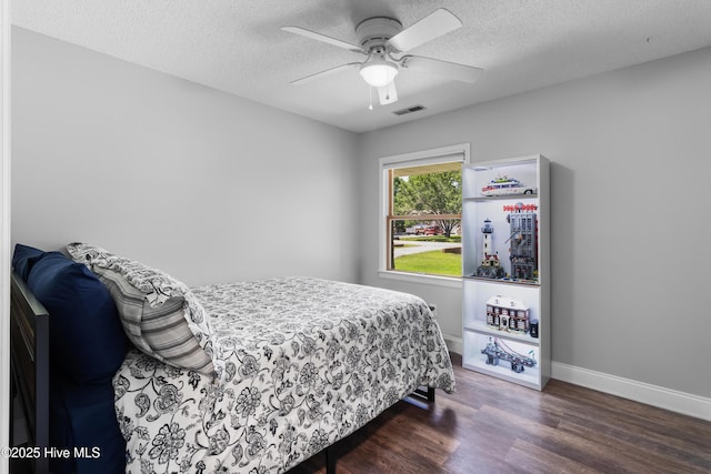 205 Sand Dollar Ln, Hampstead, NC 28443 - bedroom with wood finished floors, a textured ceiling, baseboards, and a ceiling fan