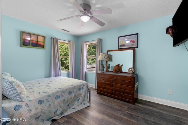 205 Sand Dollar Ln, Hampstead, NC 28443 - bedroom featuring dark wood-style flooring, baseboards, a ceiling fan, and a textured ceiling