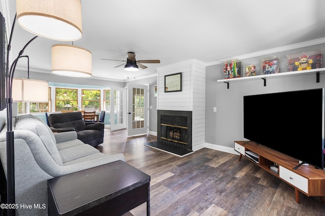 205 Sand Dollar Ln, Hampstead, NC 28443 - living area with crown molding, a ceiling fan, wood finished floors, baseboards, and a large fireplace