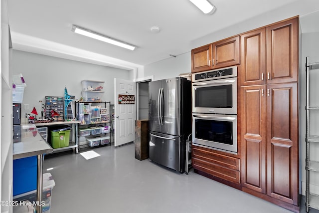 205 Sand Dollar Ln, Hampstead, NC 28443 - kitchen with stainless steel appliances, brown cabinetry, concrete floors, and light countertops