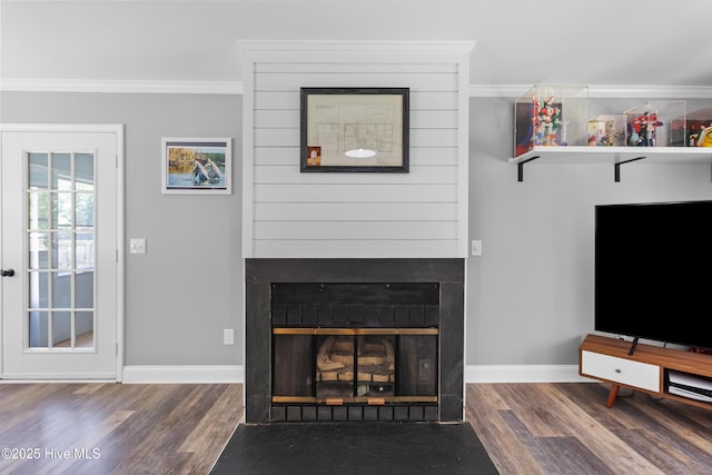 205 Sand Dollar Ln, Hampstead, NC 28443 - unfurnished living room featuring ornamental molding, a fireplace, wood finished floors, and baseboards