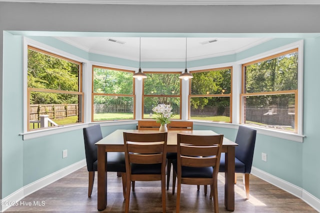 205 Sand Dollar Ln, Hampstead, NC 28443 - dining area featuring crown molding, baseboards, healthy amount of natural light, and wood finished floors