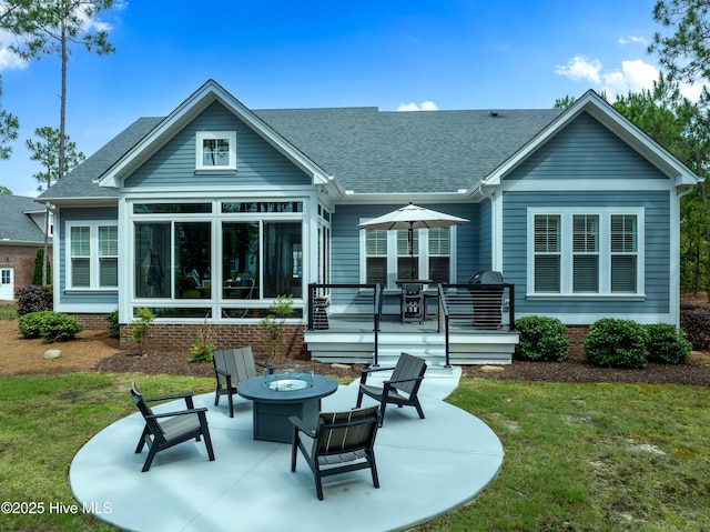 3752 Glenmere Ln, Southport, NC 28461 - back of property featuring a patio area, a fire pit, roof with shingles, and a yard