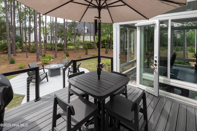 3752 Glenmere Ln, Southport, NC 28461 - wooden deck with outdoor dining area and an outdoor fire pit